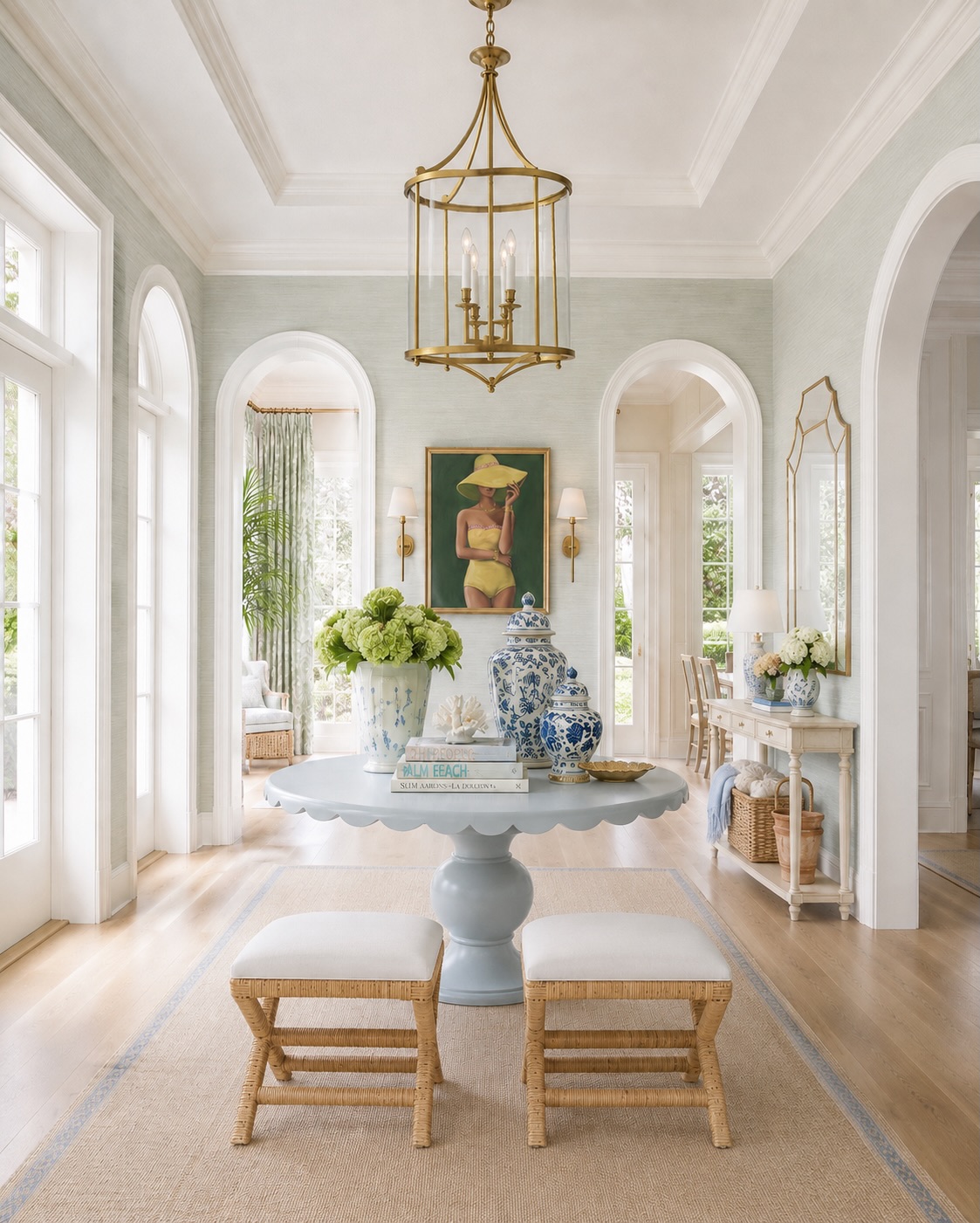 Airy Palm Beach entryway with arched openings and a blue scalloped table.